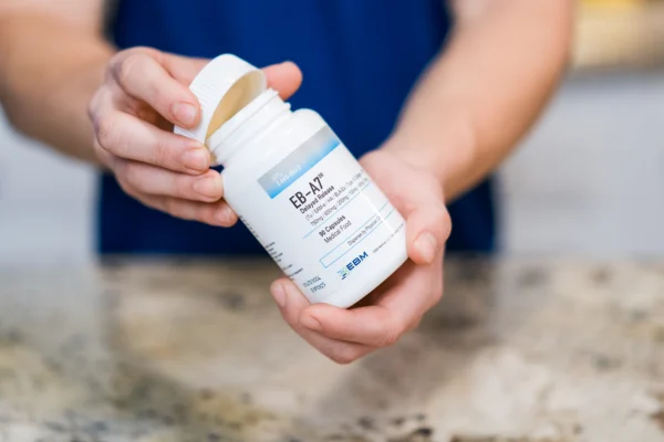 hands holding EB-A7 bottle