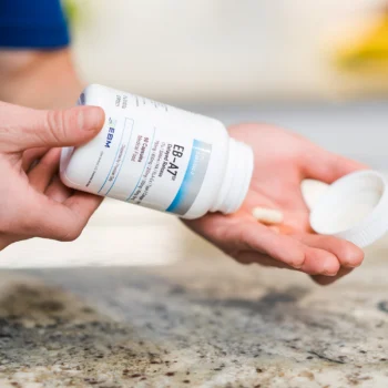 pouring capsules of EB-A7 into hand