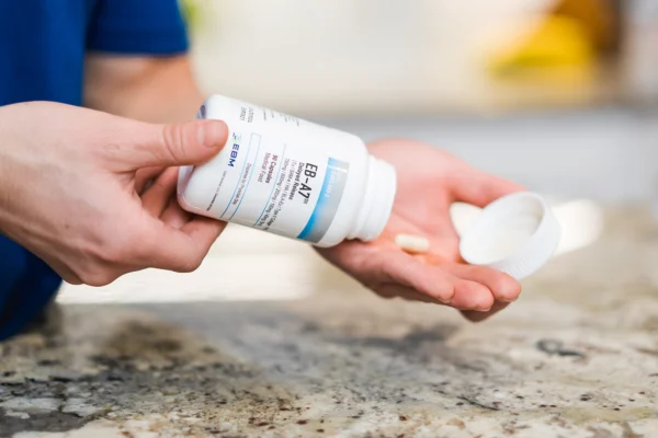 pouring capsules of EB-A7 into hand